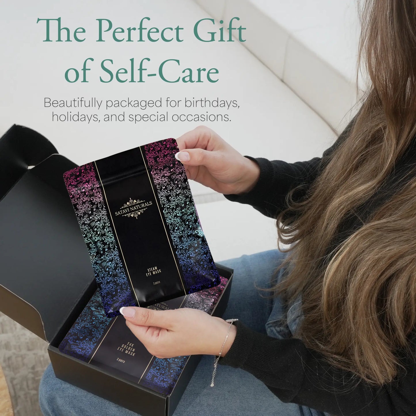 Woman opening gift box showing steam eye mask in packaging, perfect for birthdays and special occasions.