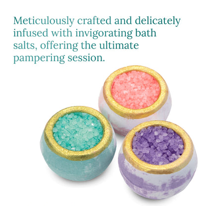Satavi Naturals crystal bath bombs in pink, teal, and purple with gold rims, infused with bath salts for a pampering spa experience.