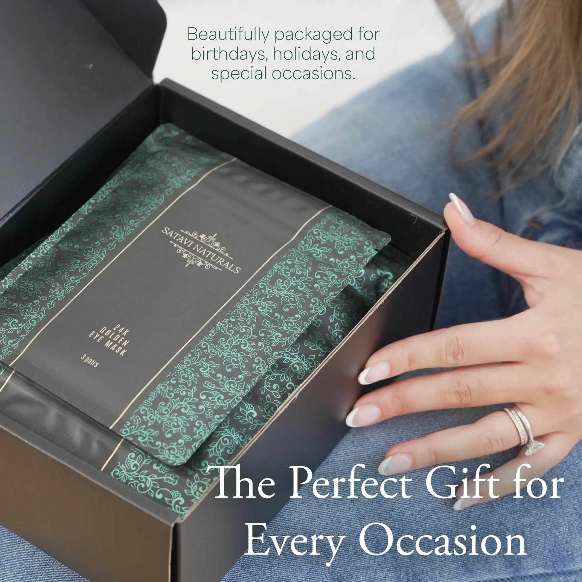 Close-up of Satavi Naturals spa gift set being opened showing shower steamers, sugar scrubs, steam eye masks, and 24k gold eye masks in decorative packaging